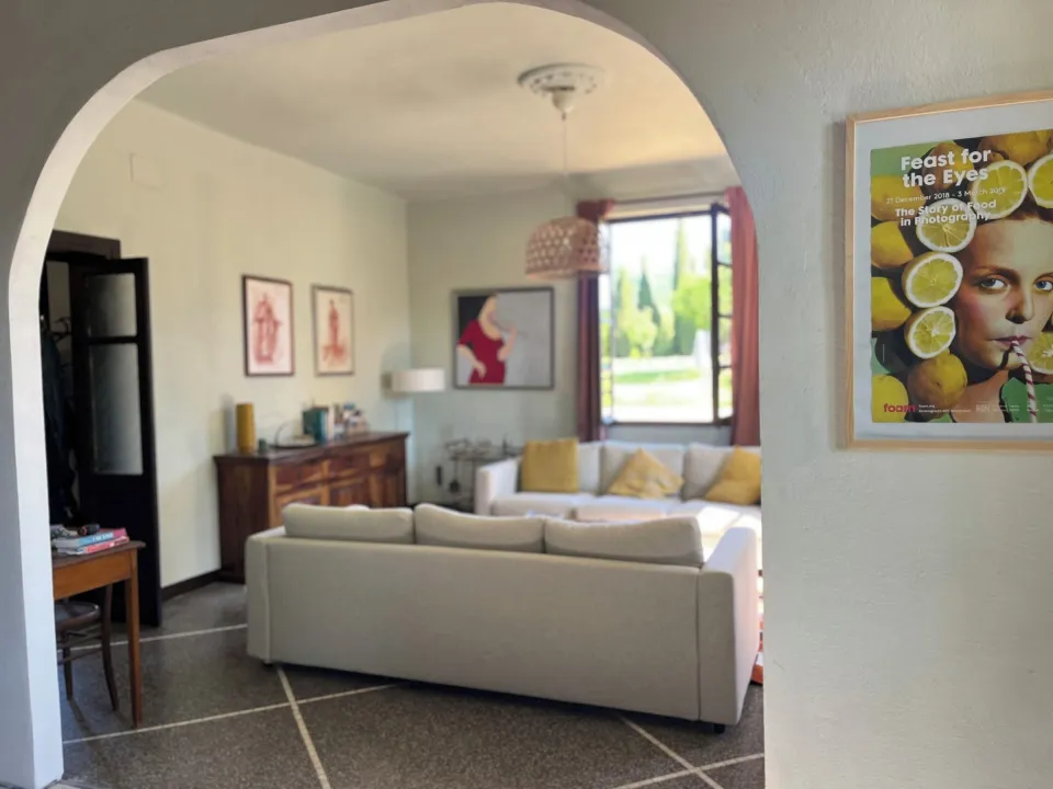 Living room with a sofa, television and poster