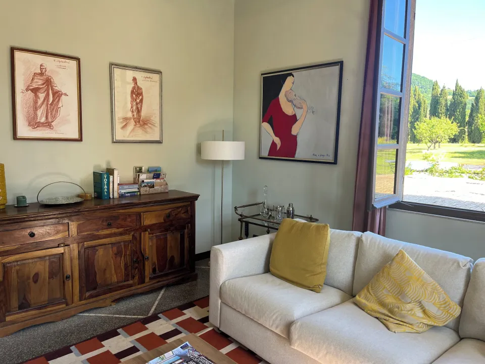 Living room with a sofa, wooden cabinet and framed art