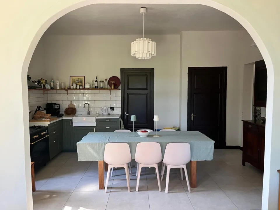 Kitchen with a central island, dining area and chandelier