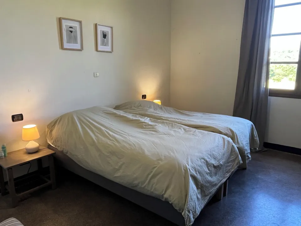 Double bed with bedside tables and framed photos