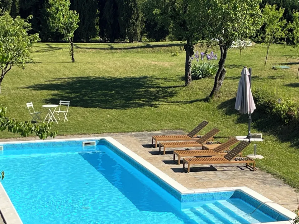Rectangular pool with tiled edge, sun loungers and seating
