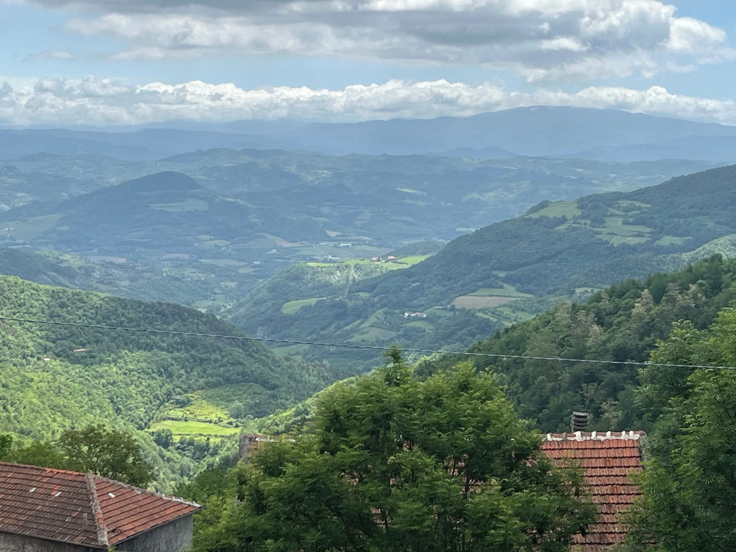 A view over the surrounding mountains and green valleys